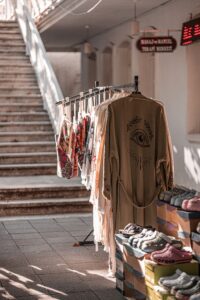 Explore a charming street market in Istanbul with traditional clothes and shoes displayed outdoors.