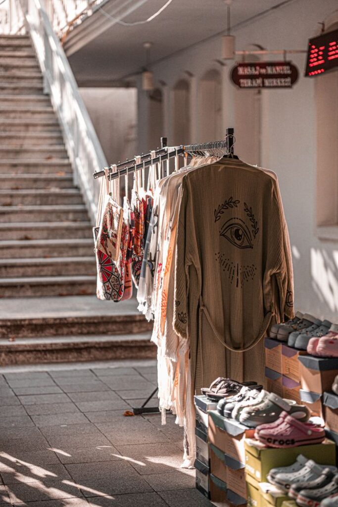 Explore a charming street market in Istanbul with traditional clothes and shoes displayed outdoors.